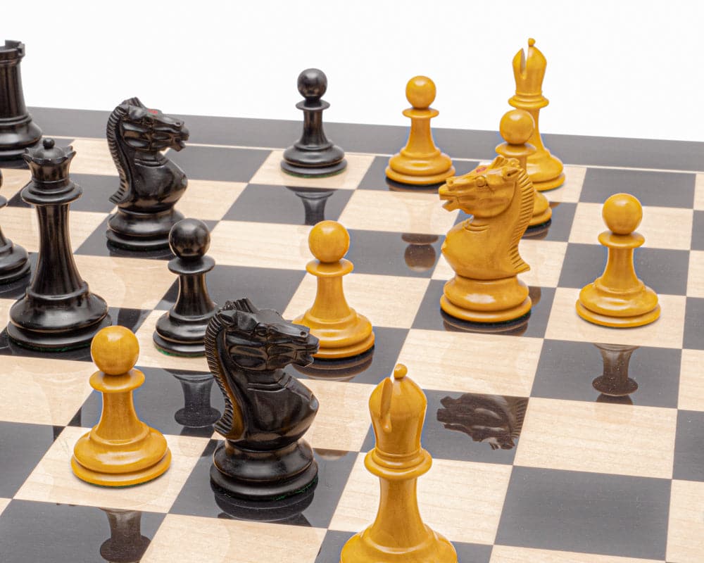 A picture of antiqued ebony chess pieces on a glossy luxury chess board