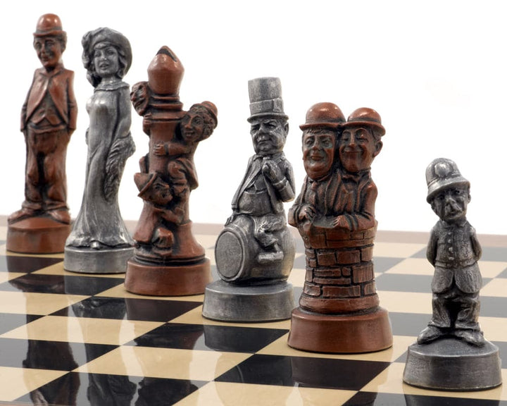 Handcrafted metallic chess pieces inspired by Hollywood's Golden Age on a chessboard, featuring a 5.25 inch King and detailed sculptures.