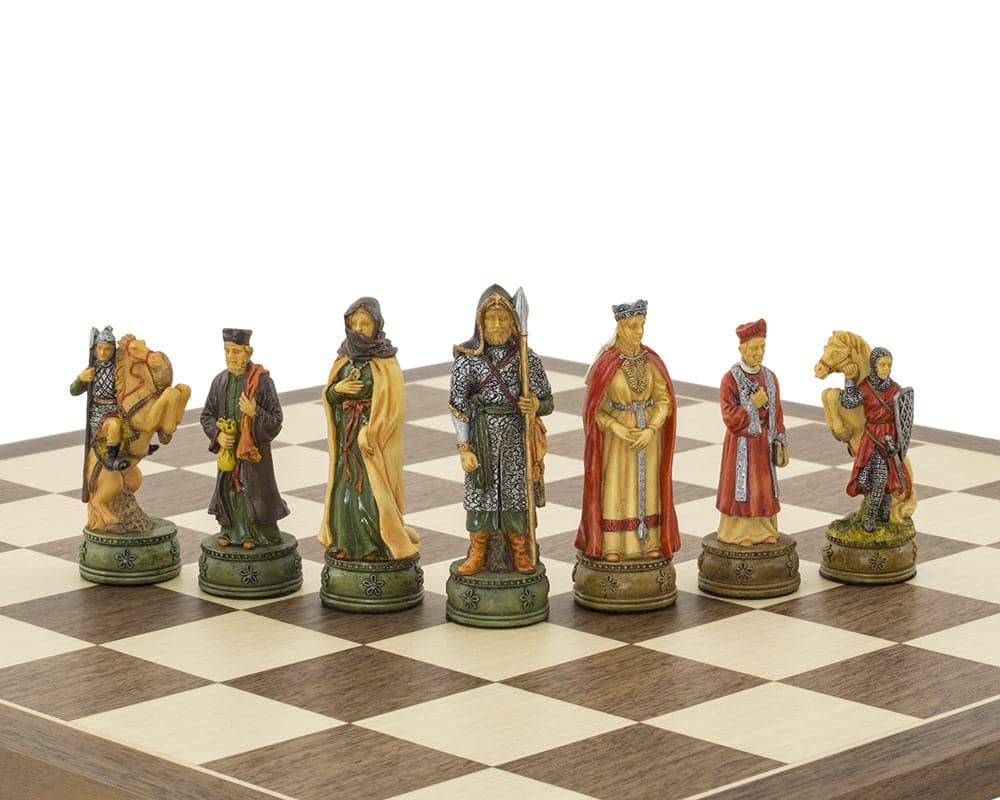 The Camelot hand-painted themed chess pieces by Italfama on a chessboard, featuring intricately detailed King Arthur characters.