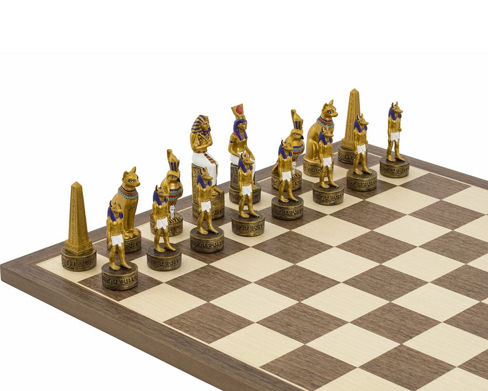 Ancient Egypt hand painted themed chess pieces by Italfama on a chessboard, featuring gold and black designs.