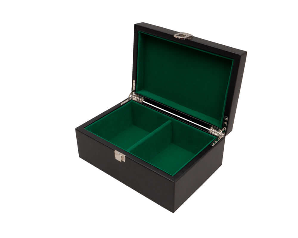 Black leatherette chess piece storage box with cushioned green interior compartments and chrome furniture, open and empty.