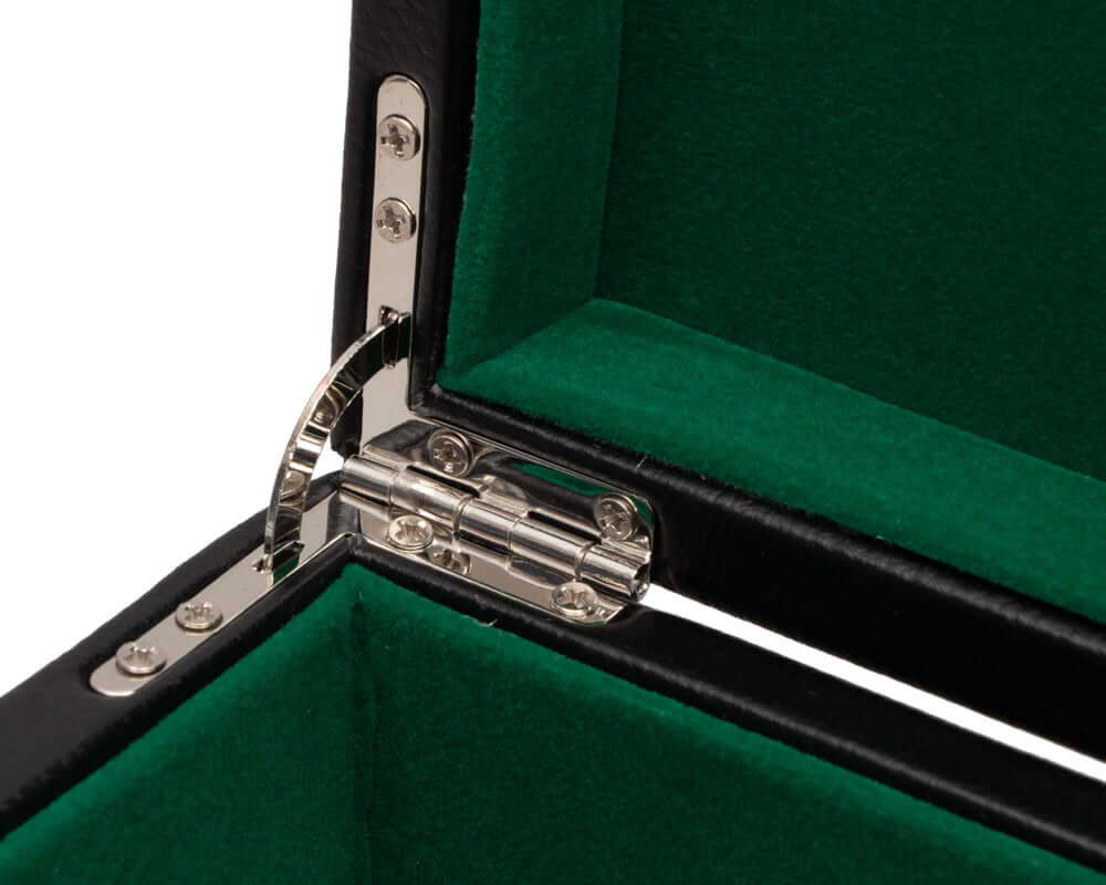 Close-up of chrome hinge inside a black leatherette chess piece case with green cushioned interior compartments.