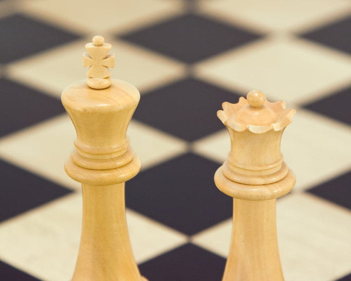 Close-up of Victoria Series Ebonised Boxwood Chessmen 3.75 inch king and queen on a chessboard.