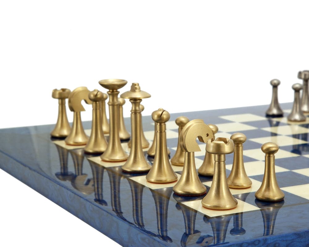 Metropolis Series brass and nickel chess pieces on blue board, hand turned by Italian craftsmen, minimalist design with 2.75" king.