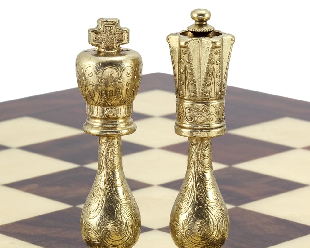 Maghreb brass and nickel chess king and queen pieces with intricate filigree detail on a chessboard