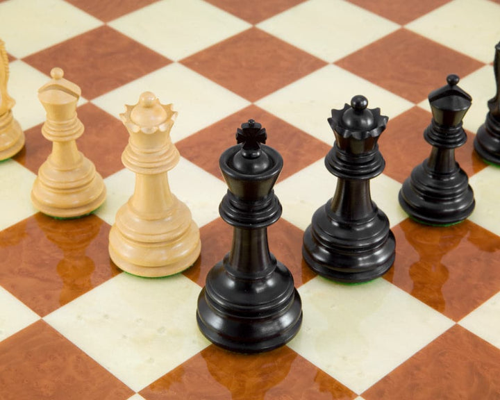 Handcrafted Cheltenham Series ebony and boxwood chess pieces on a chessboard, featuring a 3.75 inch king and two additional queens