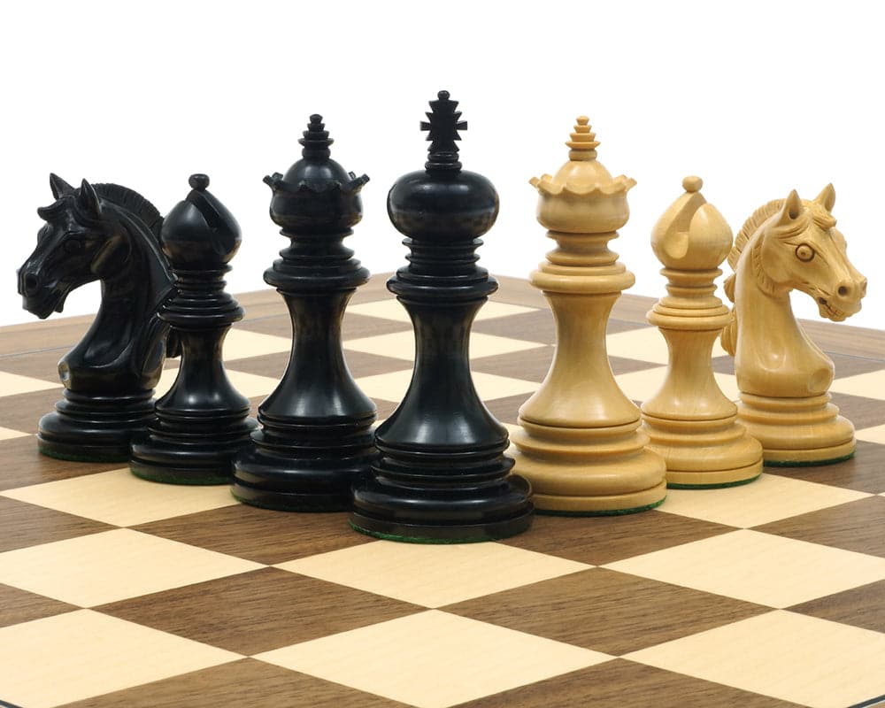 The Garvi Ebony Chessmen 4 inches with Mughal influence, Staunton design, on 23 inch board, black and ivory pieces including additional queens.