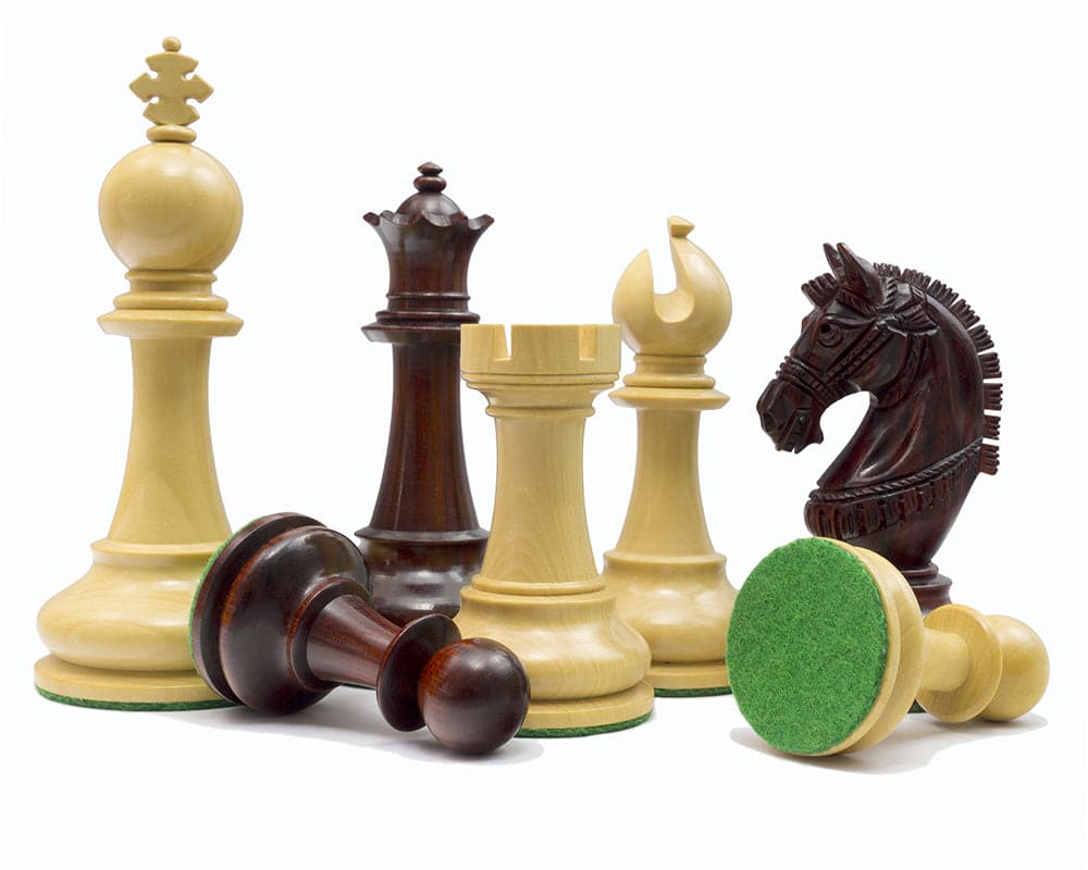 The La Valletta Redwood Chessmen 4.5 inch set with Maltese design, featuring weighted pieces and detailed knight on billiard cloth bases.