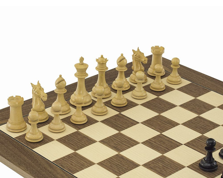 Large wooden chessboard set with Staunton-style chess pieces, prominently featuring two rows of elegantly carved light wood pieces.