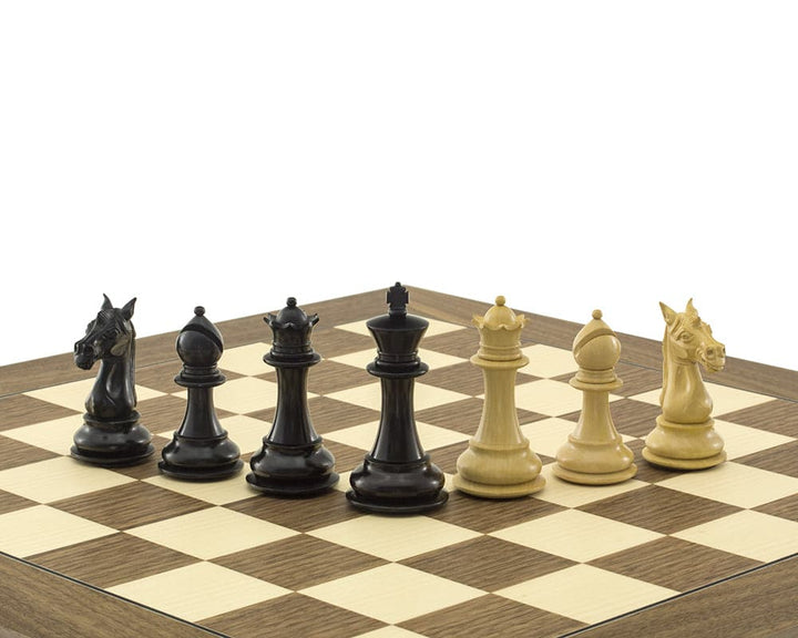 Columbus Series Chessmen Ebony 4" - Black and ivory Staunton chess pieces on a chessboard, including king, queen, bishop, knight, and rook.