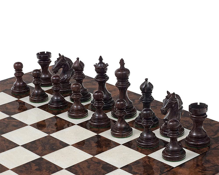 The Garvi 4 inch Rosewood Chessmen set up on a checkered chessboard, showcasing finely detailed, solid rosewood pieces inspired by 16th century Indian history.