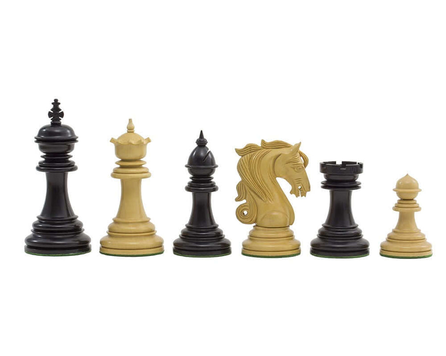 The Kingsgate Ebony Chessmen set featuring 4.25 inch pieces crafted from solid ebony and boxwood, showcasing ornate and intricately carved knights.