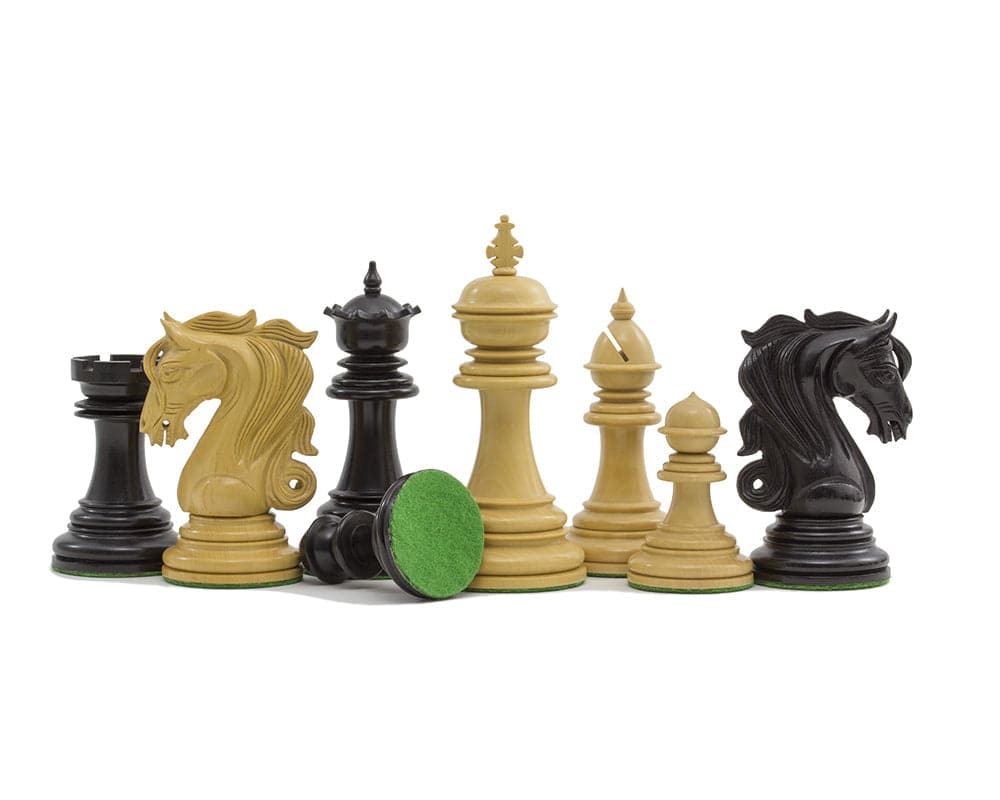 The Kingsgate Ebony Chessmen 4.25 inch set with intricate carvings, ebony and ivory pieces, green billiard cloth base.