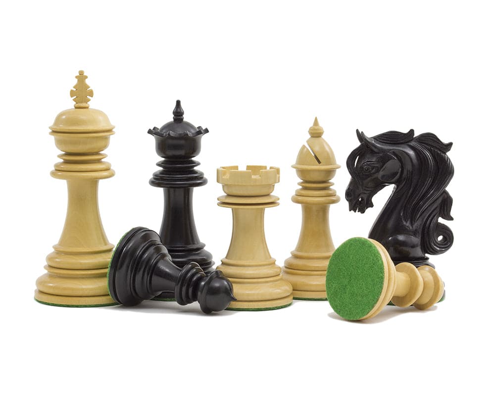 The Kingsgate Ebony Chessmen set with 4.25 inch King, intricately carved knights, and billiard cloth bases, expertly crafted from solid ebony.