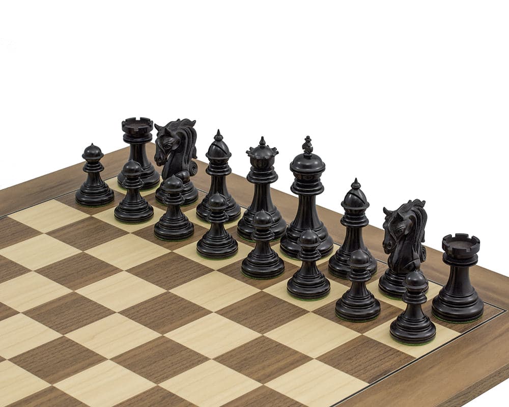 The Kingsgate Ebony Chessmen 4.25 inch set on a 21.7 inch board. Solid ebony pieces with intricate carvings, including the knight and 4.25 inch king