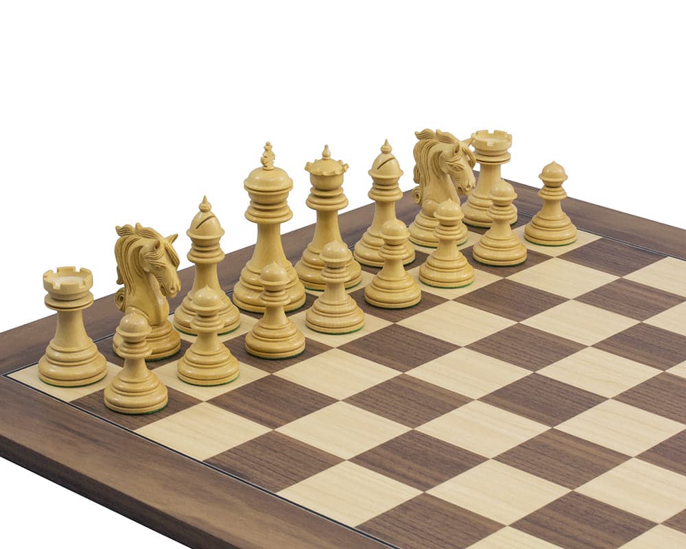 Intricately carved ebony chess pieces on a chessboard, featuring ornate knights and a 4.25-inch King.