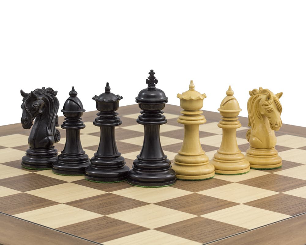 The Kingsgate Ebony Chessmen 4.25 inch set on a 21.7 inch board, featuring black and natural pieces with ornate knights and finely detailed carvings