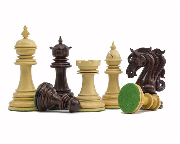 Handcrafted rosewood chessmen featuring ornate knight, 4.25 inch king, and additional queens. Weighted and balanced with billiard cloth bases.