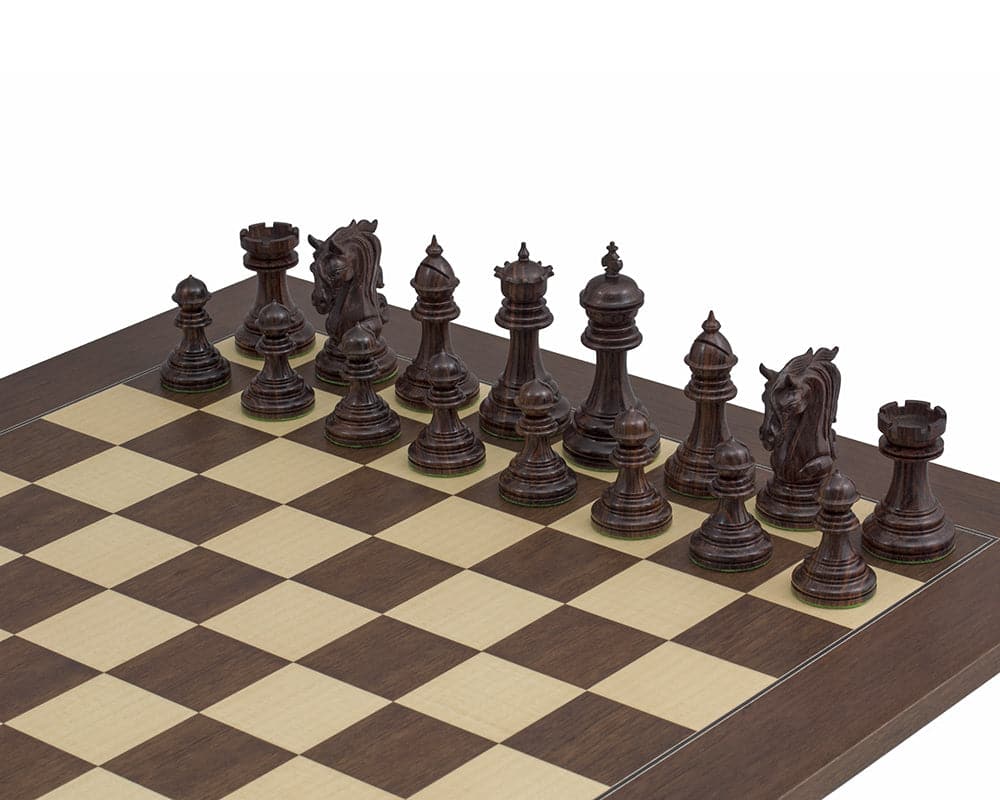 The Kingsgate Rosewood Chessmen 4.25 inch ornately carved set displayed on board, handcrafted with intricate detail and perfect balance.