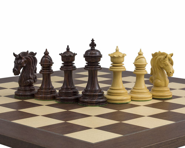 The Kingsgate Rosewood Chessmen 4.25 inch set, handcrafted and ornate, displayed on a chessboard showing intricate knight carvings and weighted bases.