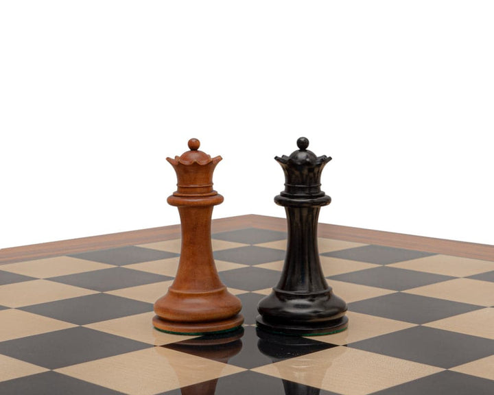 Reproduction Staunton 1849 Chessmen 4.4 inch King in antiqued boxwood and ebony on chessboard.