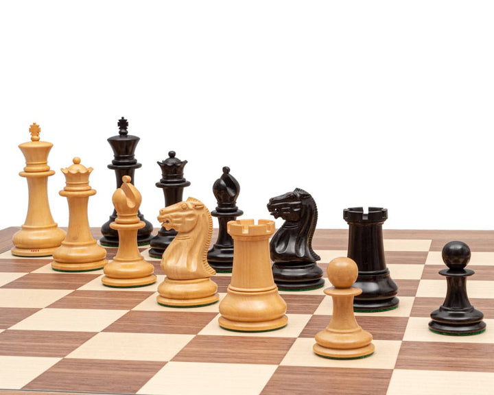 1851 Reproduction Staunton Ebony Chessmen set with 4.4 inch king and broad 2 inch bases displayed on a chessboard.