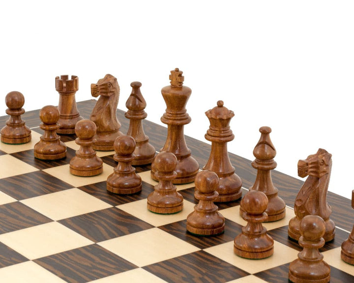 The Rochester Ebony Chessmen 4 inch Staunton design on a chessboard, featuring expertly crafted wooden pieces with a 4-inch king.