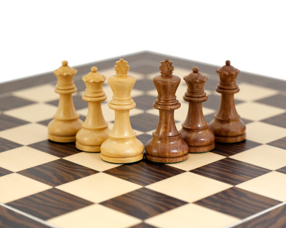 Rochester Ebony Chessmen 4 inch set on chessboard with traditional Staunton design and additional queens.