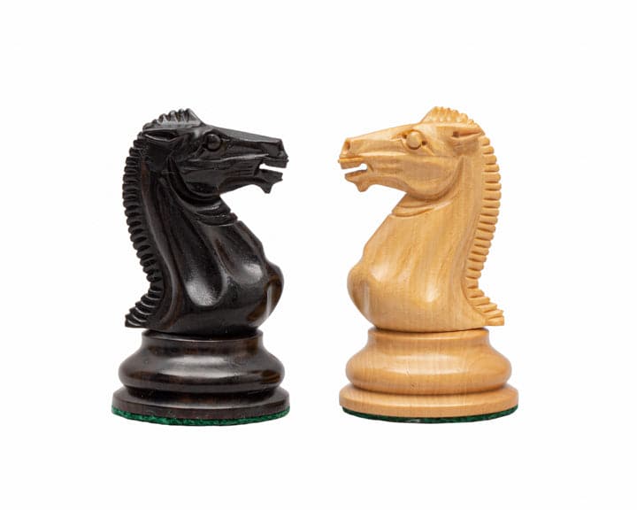 Rochester Ebony Chessmen set featuring black and white knight pieces with traditional Staunton design, skillfully crafted for balance and elegance