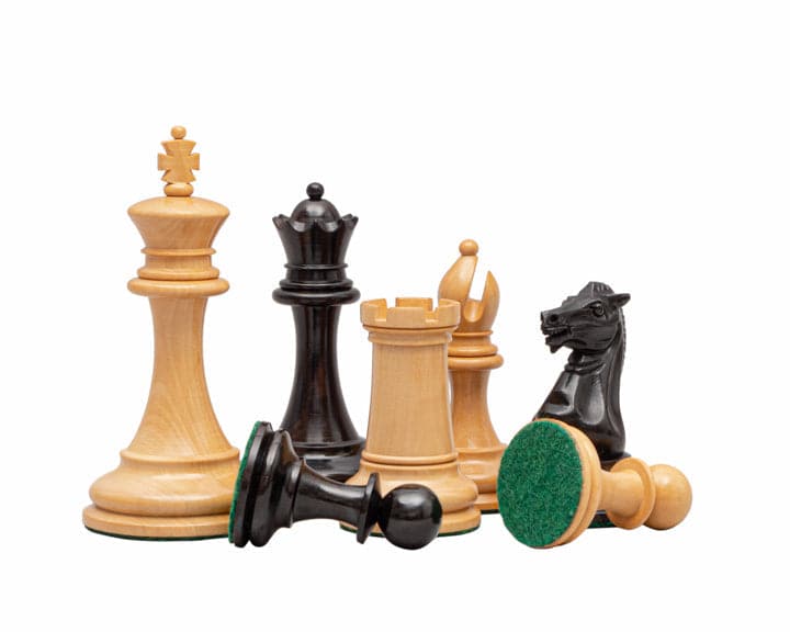 The Rochester Ebony Chessmen 4 inch Staunton design set with weighted and billiard cloth-covered bases, crafted by expert artisans.