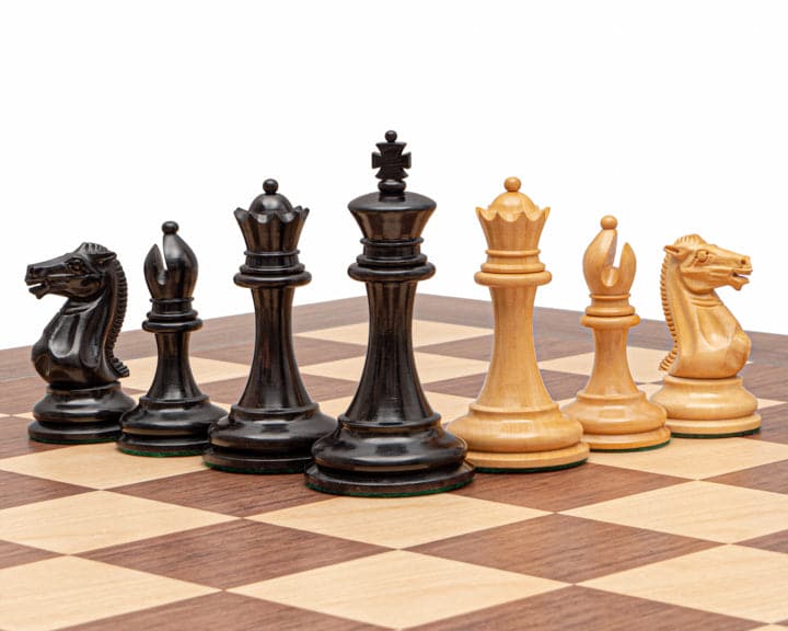 The Rochester Ebony Chessmen 4 inch set on a chessboard, featuring traditional Staunton design with 4 inch king and weighted bases