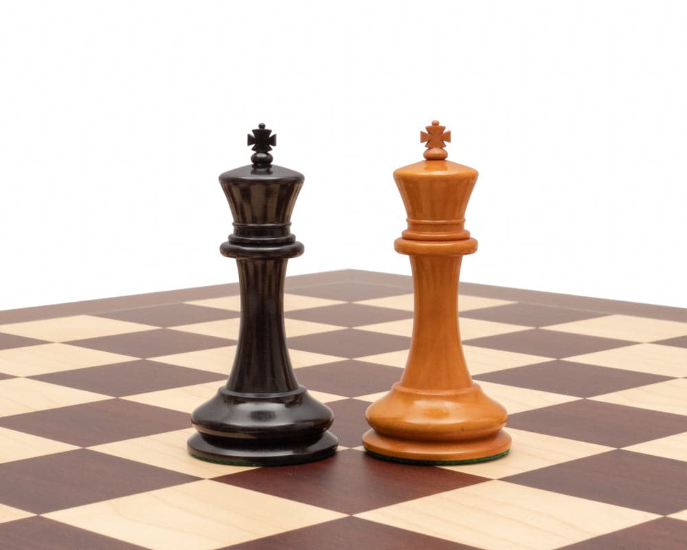 J J Cooke Edition 4.4 inch ebony and antiqued boxwood chessmen, exquisite craftsmanship on a chessboard with broad felted bases.