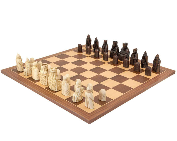 The Isle Of Lewis Walnut and Maple Chess Set with exquisitely detailed chessmen on an elegant chessboard.