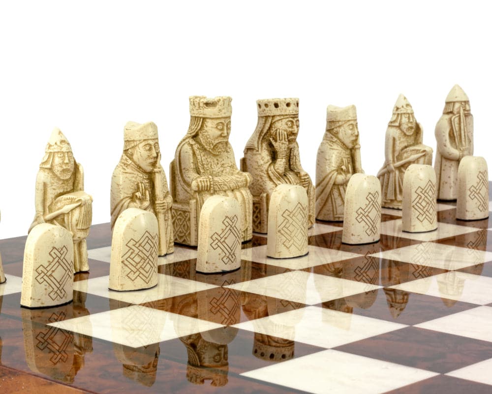 Isle of Lewis chessmen on Italian Briarwood chess board with intricate detailing.