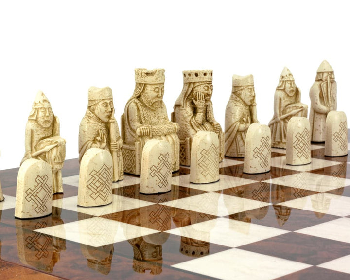 Isle of Lewis chessmen on Italian Briarwood chess board with intricate detailing.