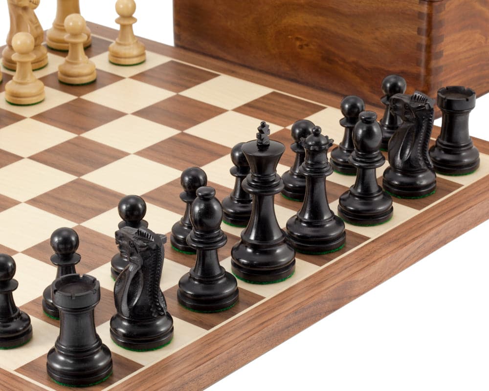 Supreme Ebony Tournament Chess Set on Walnut and Maple board with Sheesham wood case in background.