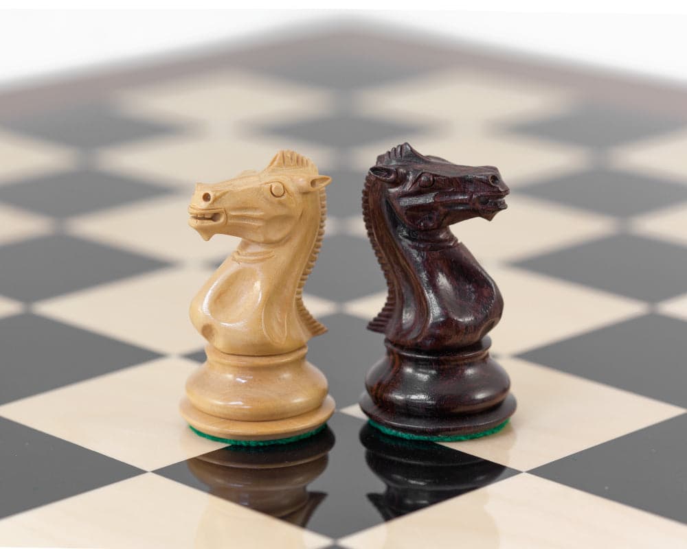 Rosewood and beige knight chess pieces on high gloss Rosewood Palisander and black Anegre chess board