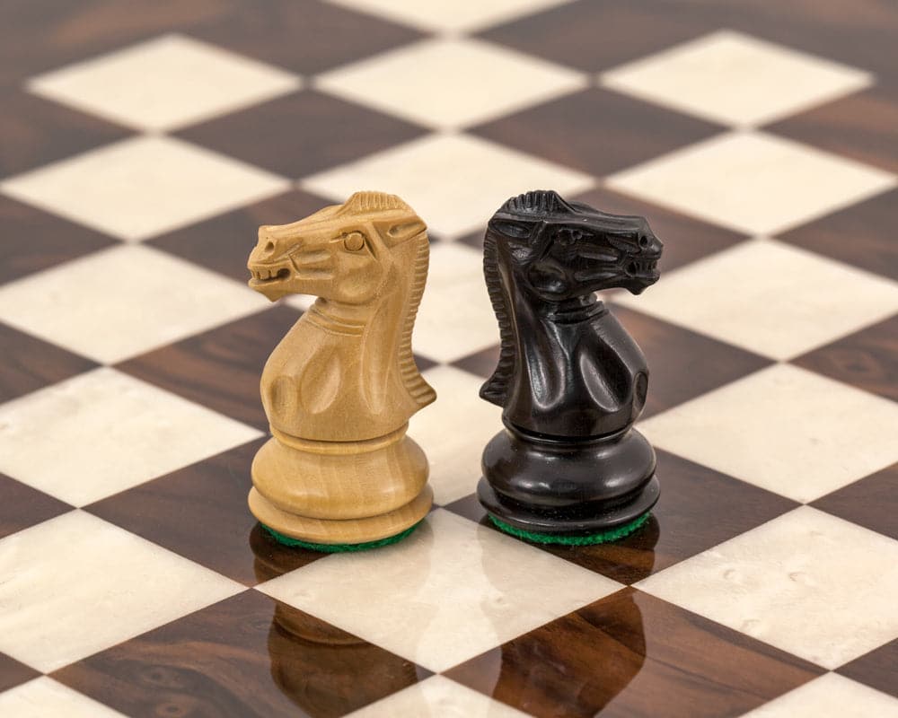 Highclere ebony and walnut knights on Italian chess board from luxury chess set