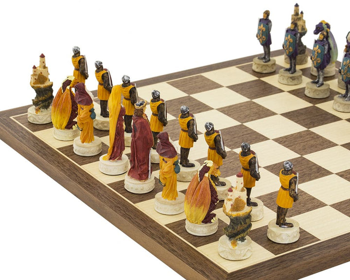 Medieval hand-painted chess set with King Arthur inspired pieces in vibrant red, orange, blue, and purple on a Spanish board