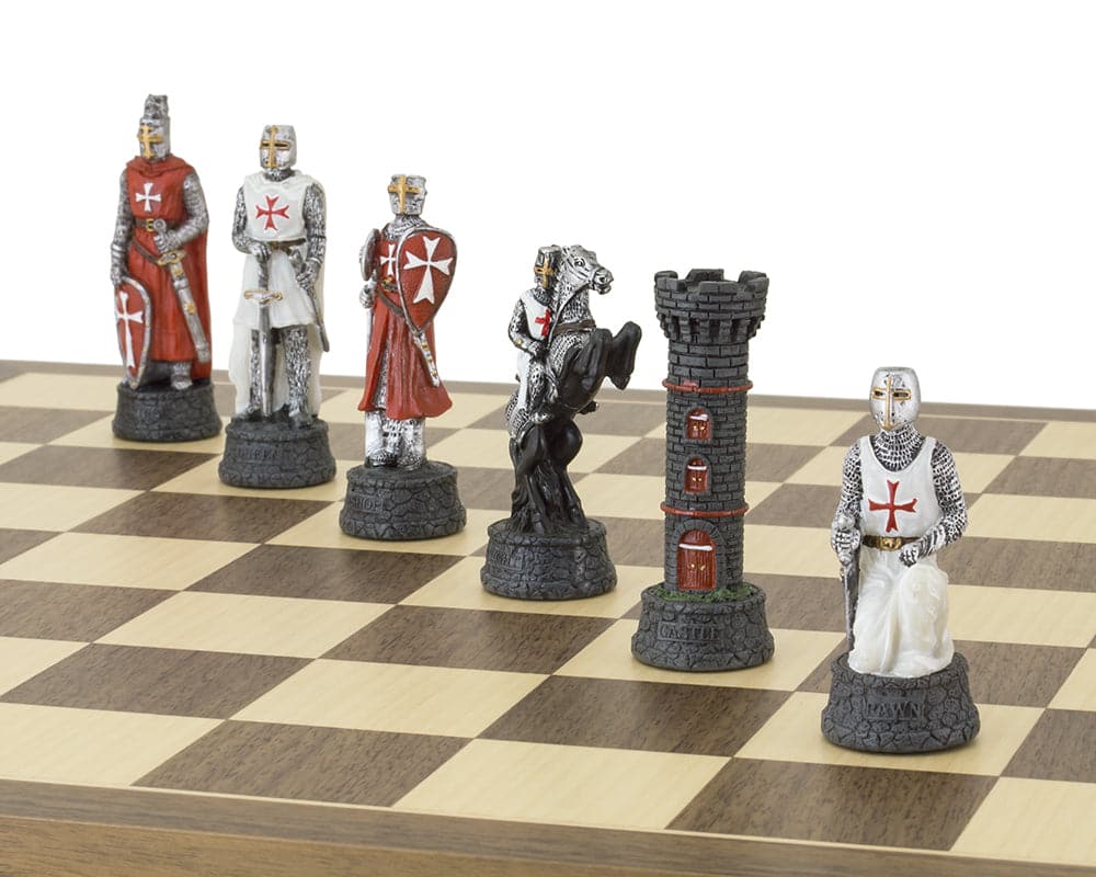 Close-up of The Crusader Hand Painted Chess Set by Italfama on a chessboard, showcasing detailed knight, rook, and bishop pieces.