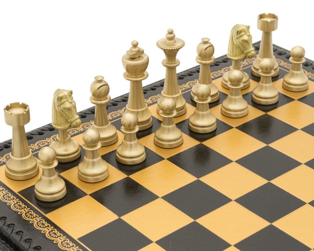 The Turin Nero Italian Chess Set with gold and black chess pieces on a black and gold leatherette chess board, close-up view.