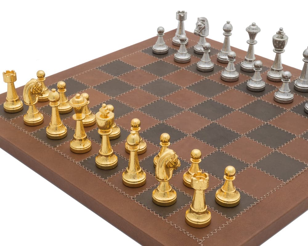 The Messina Gold and Silver Italian Leather Luxury Chess Set on a modern leather chessboard with metal chess pieces