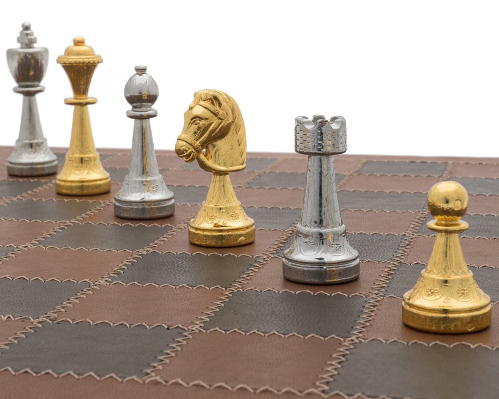 The Messina Gold and Silver Italian Leather Luxury Chess Set on board displaying gold and silver chess pieces.