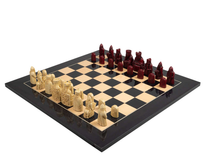 The Isle of Lewis Black and Red Chess Set with 3.25 inch kings, red and cream pieces on a chessboard, superb gift packaging.