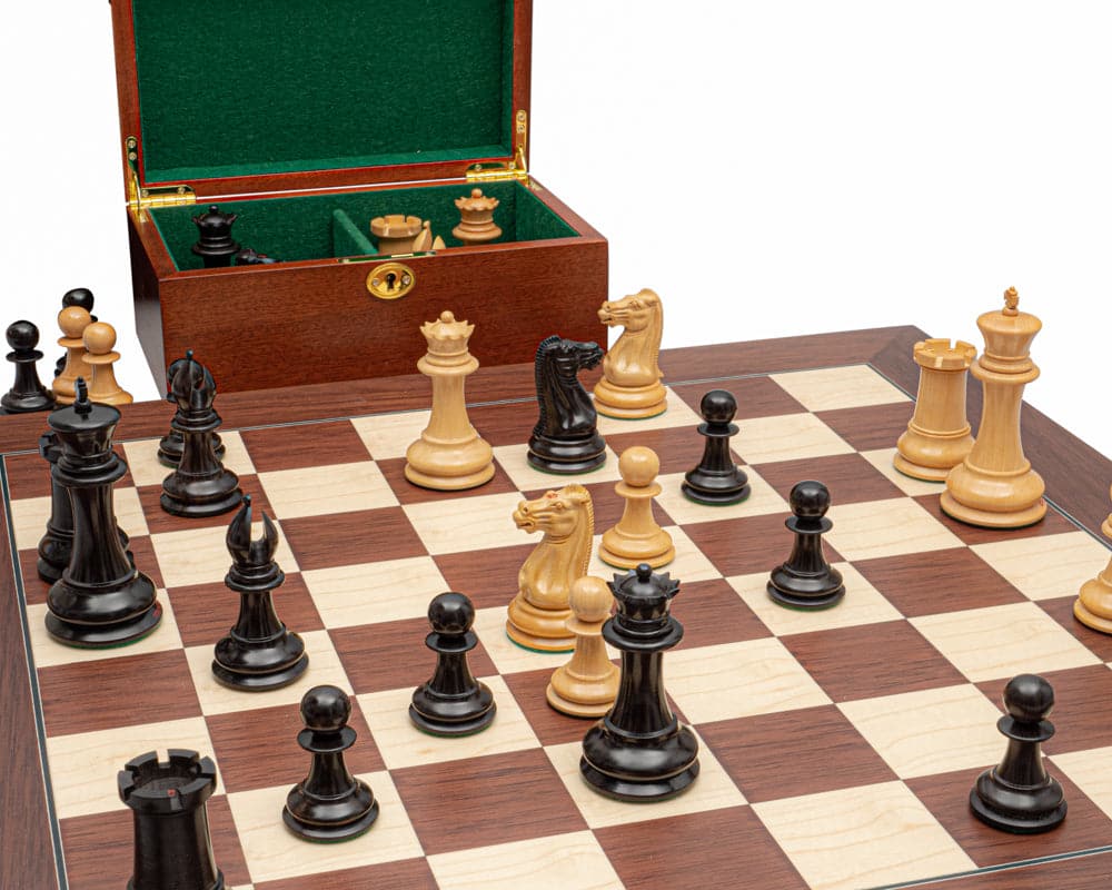 Luxury chess set with ebony and palisander pieces, 23.6 inch board, and mahogany cabinet with brass lock on green flock lining.