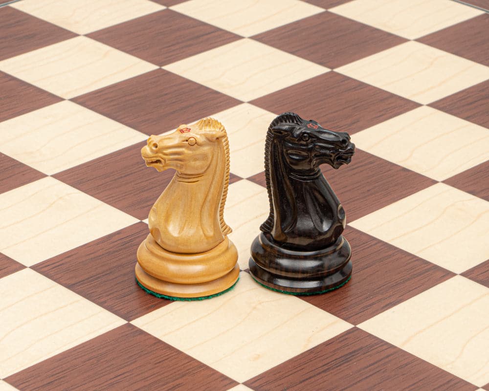 Close-up of intricately carved ebony and palisander knight chess pieces on a luxury Staunton chessboard from the 1849 Original Chess Set.